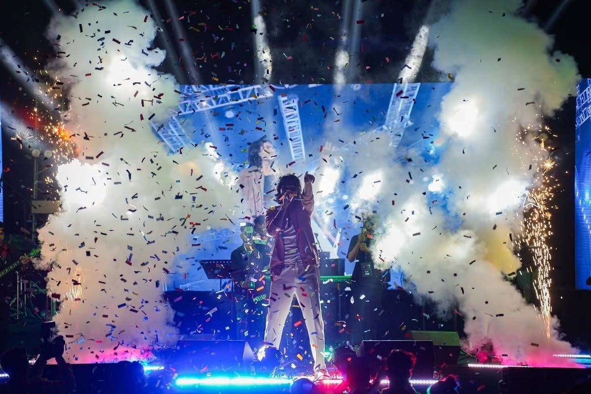 CO₂ jets, confetti and sparkler fountains erupt around Gajendra Verma on stage.