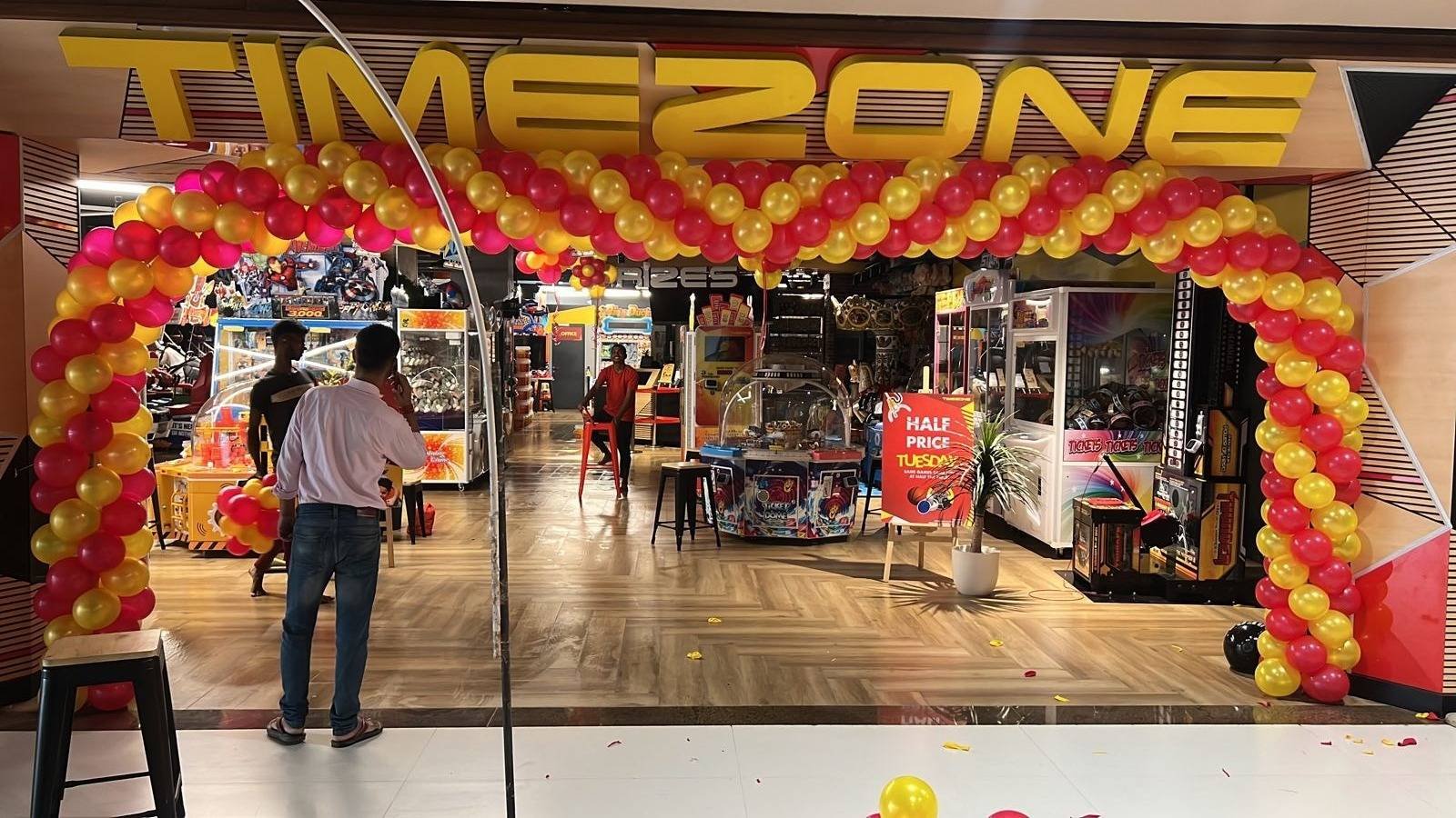 Timezone entrance framed by a red-and-yellow balloon arch for its launch.