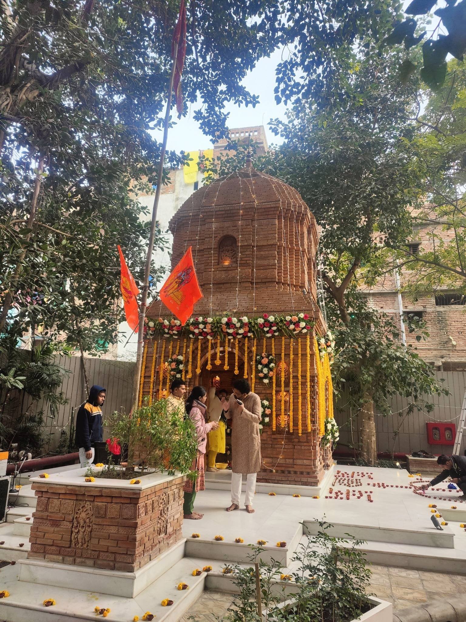 A temple structure dressed with marigold garlands and floral décor.